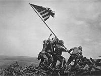 Marines raising the American flag at the summit of 
     Mt. Suribachi (Feb. 23. 1945) during the battle for Iwo Jima, 
     Photocredit http://www.ibiscom.com/iwoflag.htm